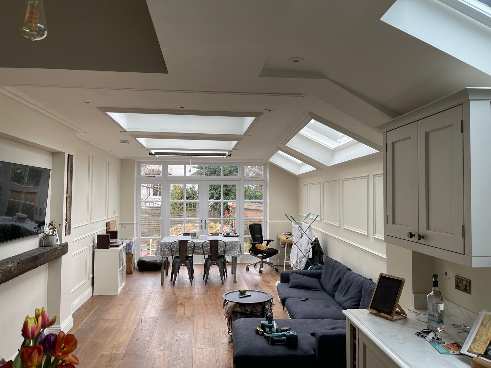 Wrap-around extension interior with skylights and panelled walls