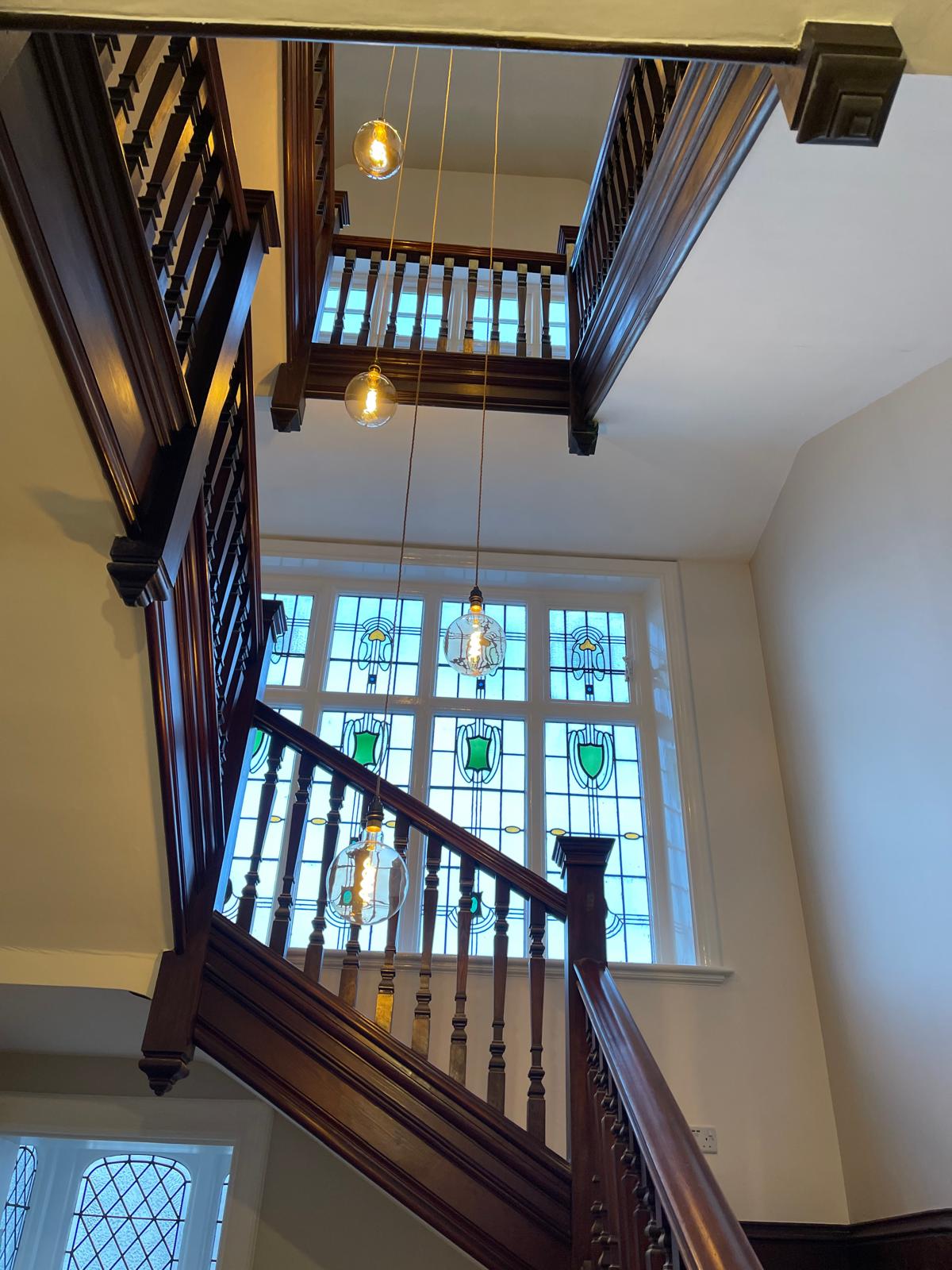 Period staircase and stained glass window in extended townhouse