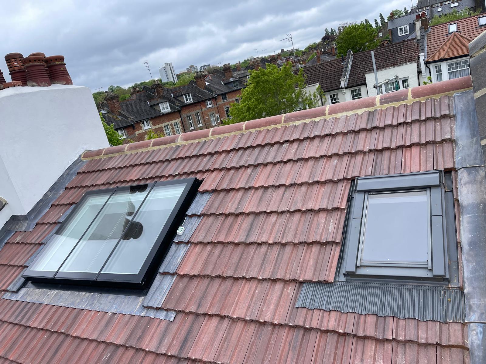Close-up of new skylights installed on a refurbished tiled roof