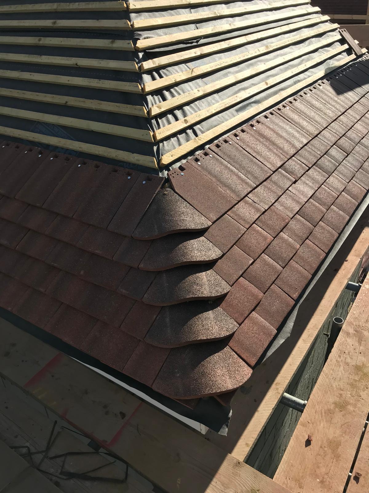 Detail of bonnet hip tiles on a freshly laid clay tile roof