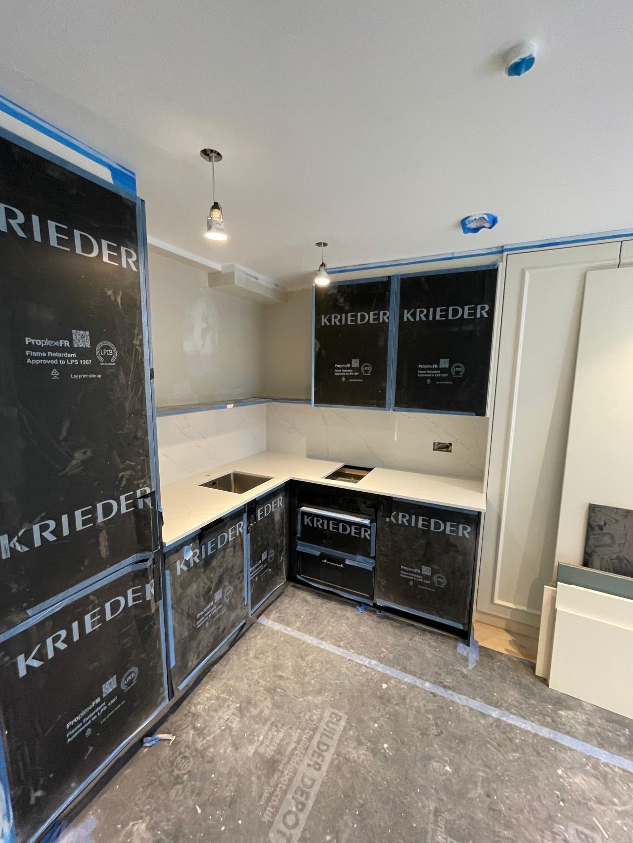 New utility kitchen install with marble worktops protected during refurbishment