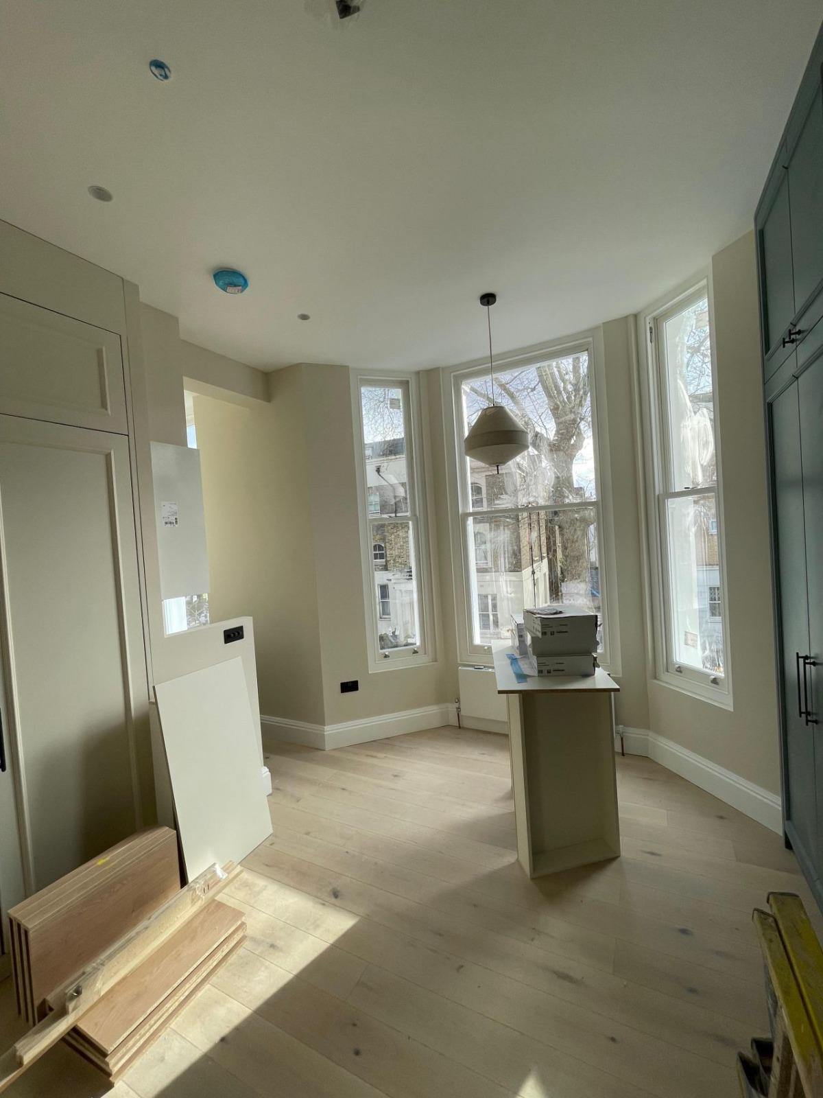Period reception room refurbishment with bay windows and new oak flooring