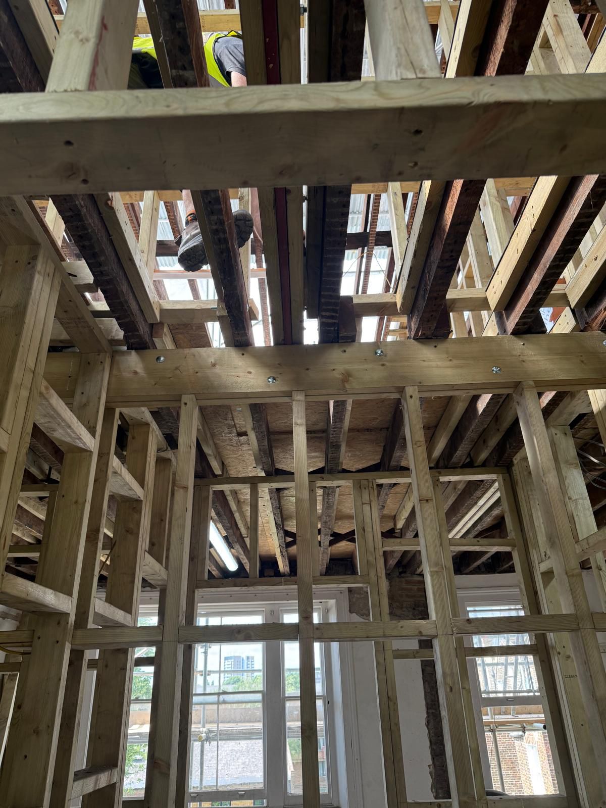 New timber floor joists and roof framing during structural refurbishment