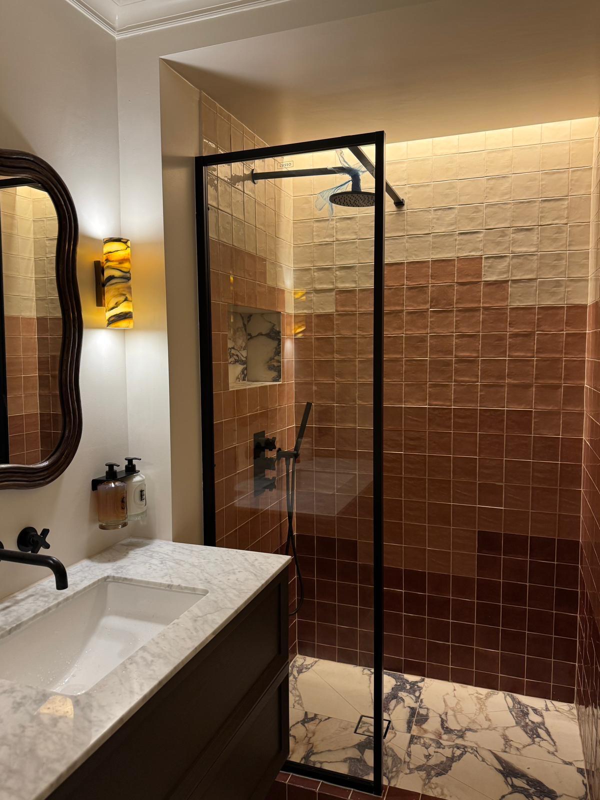 Refurbished bathroom with terracotta zellige tiles, marble vanity and walk-in shower