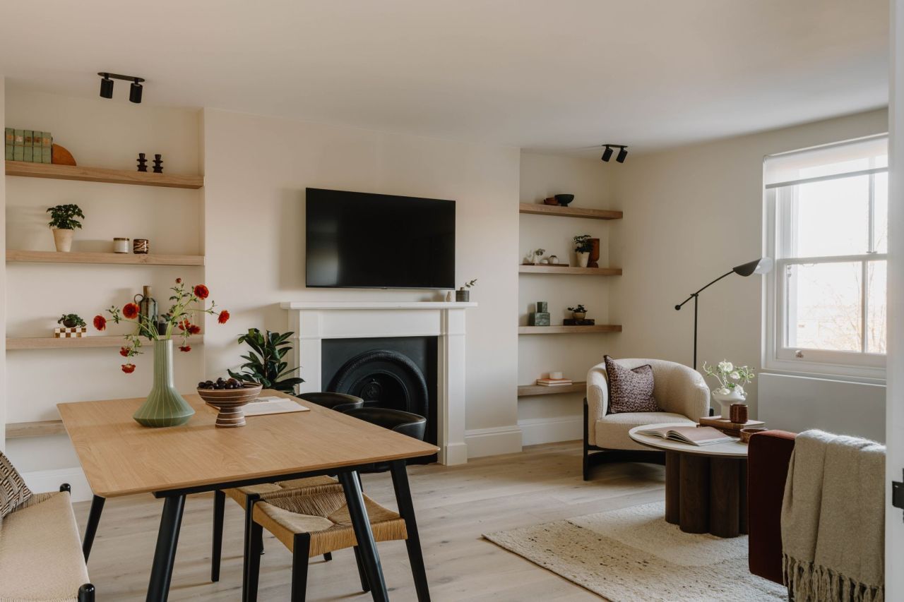 Refurbished living room with floating oak shelves and period fireplace