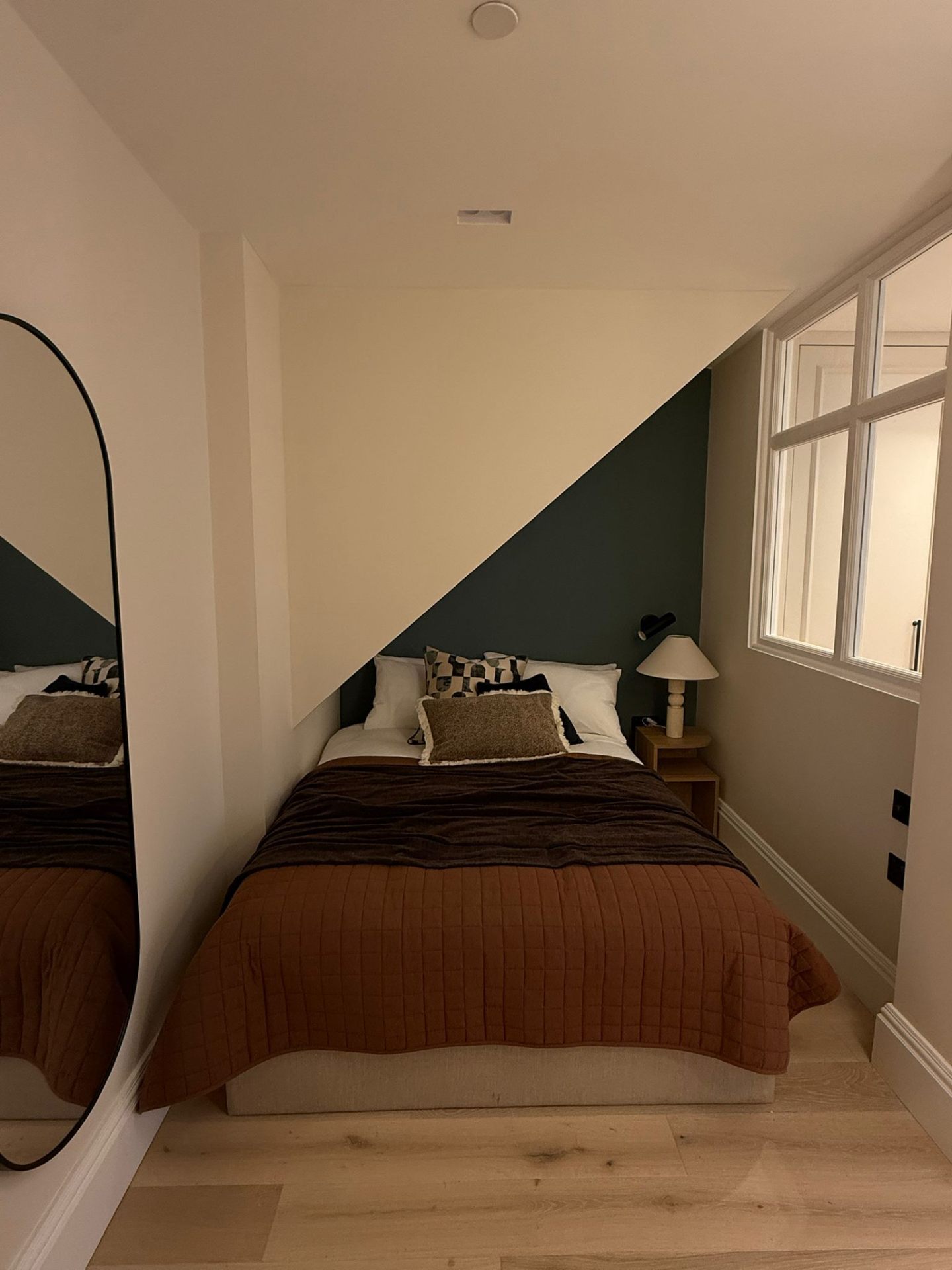 Compact bedroom with two-tone painted feature wall